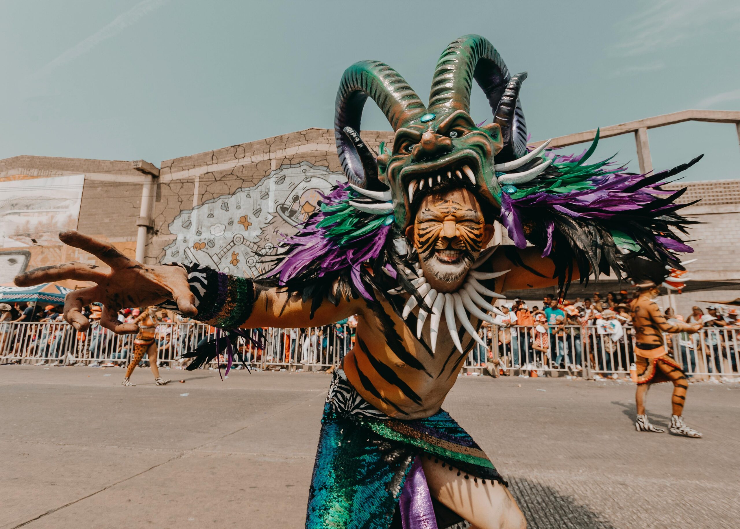 Dynamic street parade featuring vibrant Diablo Cojuelo costumes at a Dominican carnival.